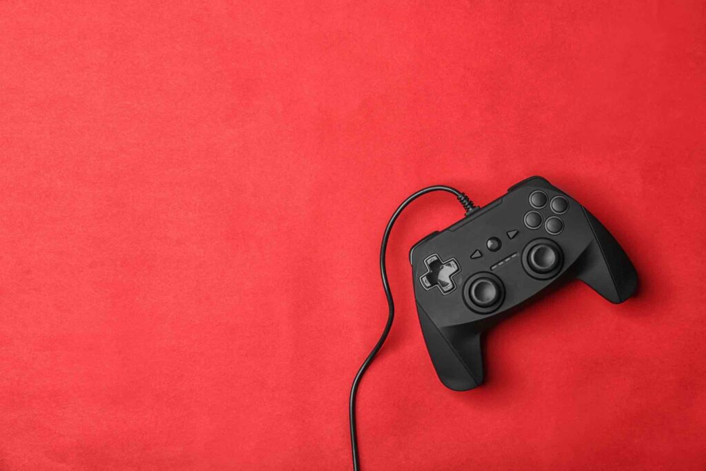 Video game controller on color background